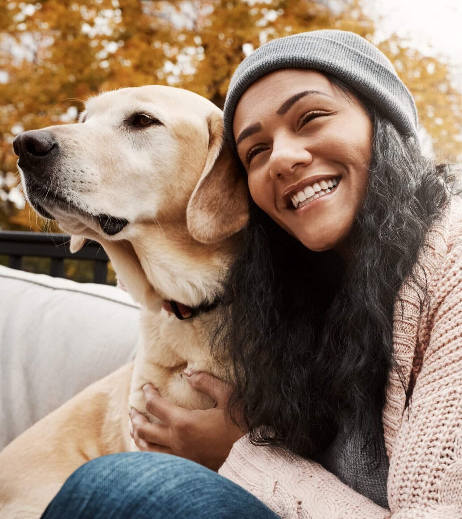 Happiness, woman and dog on bench for hug, adoption and loyalty in garden. Mental health, female person and emotional support animal in autumn with labrador, therapy and relief from anxiety with pet
