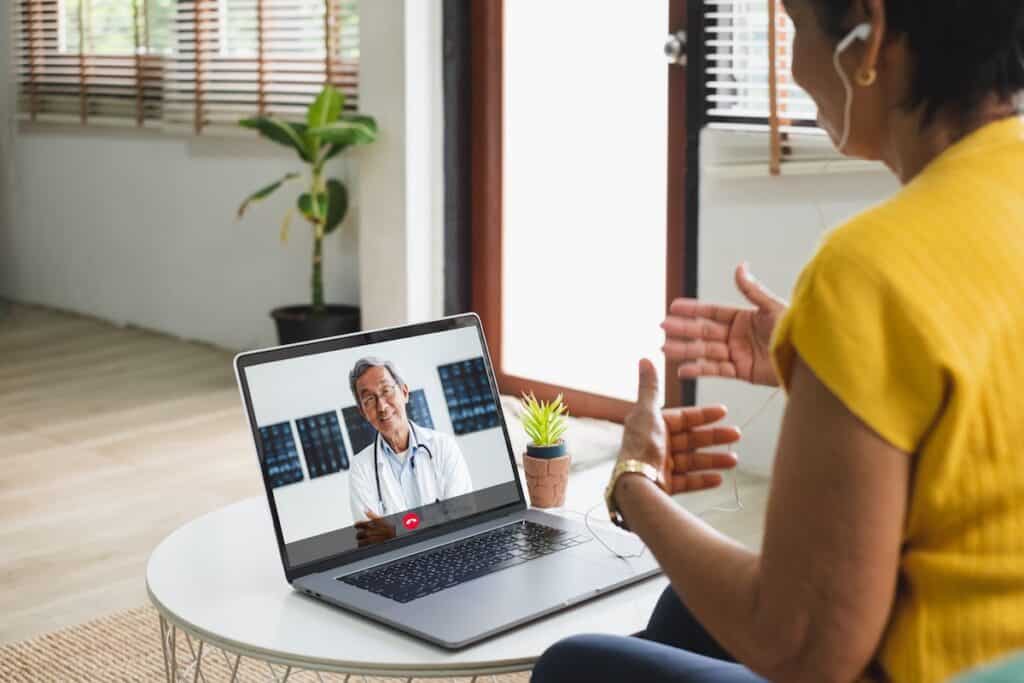 Senior on telehealth video call with a CMed cannabis doctor